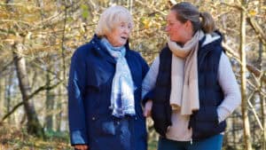 Elderly mother and daughter walking