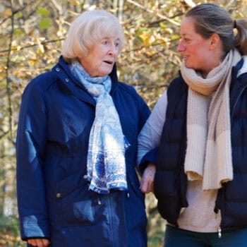 Elderly mother and daughter walking