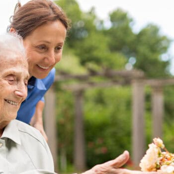 live-in carer and client in garden