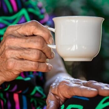 old lady holding tea cup