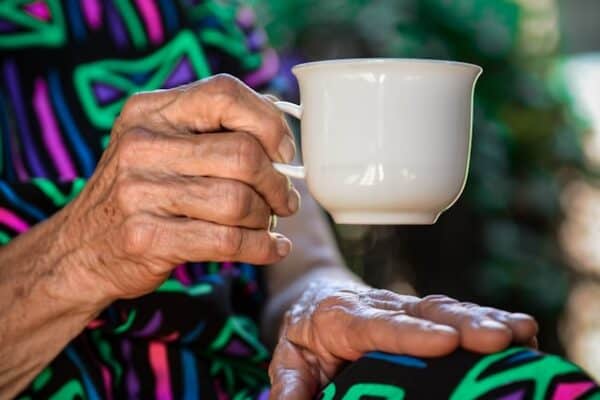 old lady holding tea cup