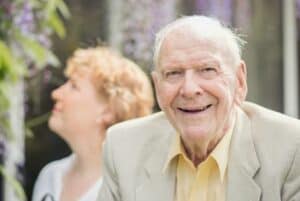 Elderly man with his daughter in garden