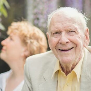 Elderly man with his daughter in garden